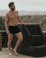 Man standing outside in a NADS Black Organic Cotton Boxer. 
