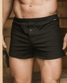 Man standing, facing the camera in a NADS Black Organic Cotton Boxer. 
