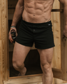 Man standing, facing the camera, coming out of a sauna in a NADS Black Organic Cotton Boxer. 